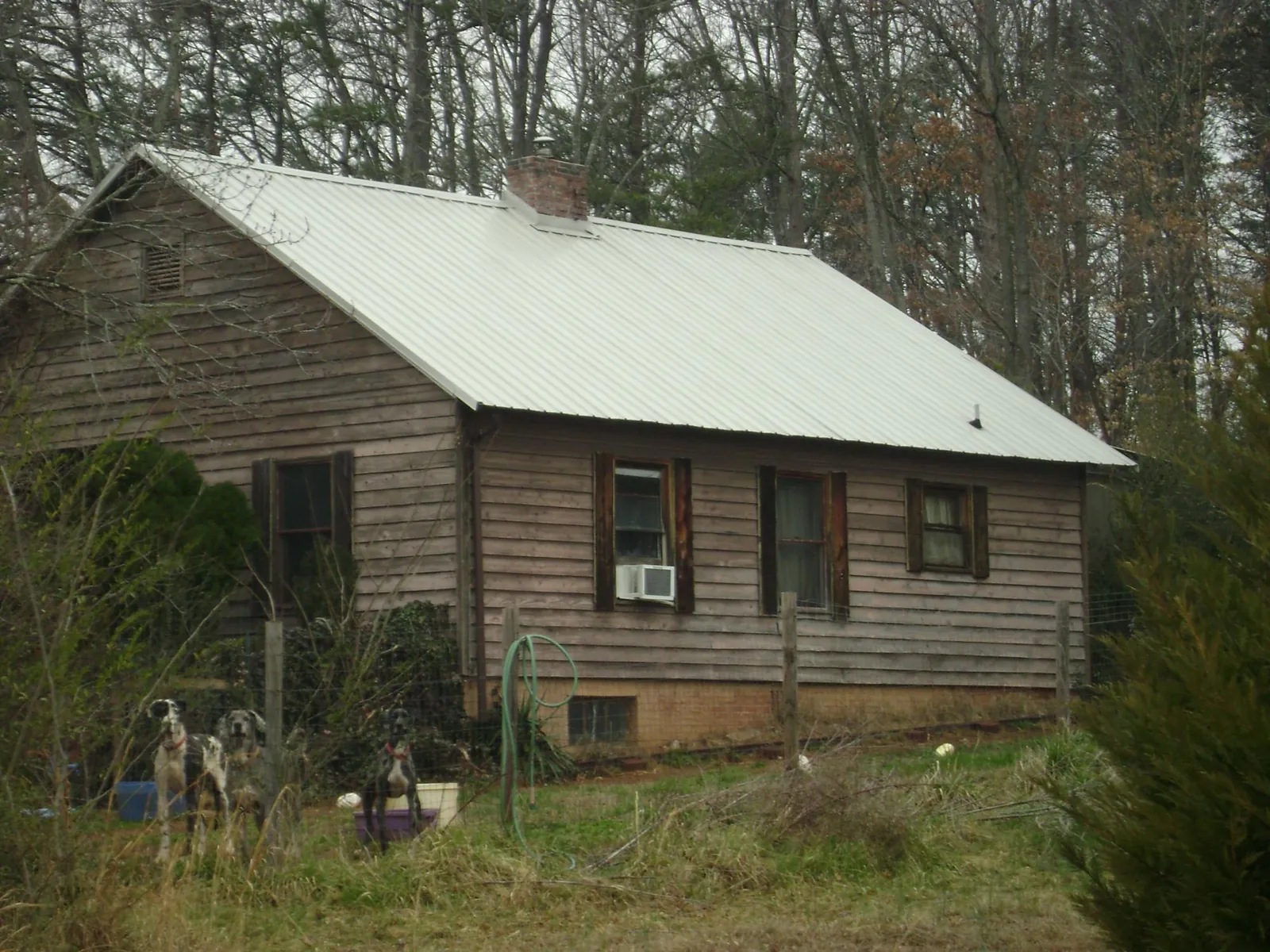 White metal roof on an old wood sided farmhouse, from a Metal Roof Installation job in Bouckville